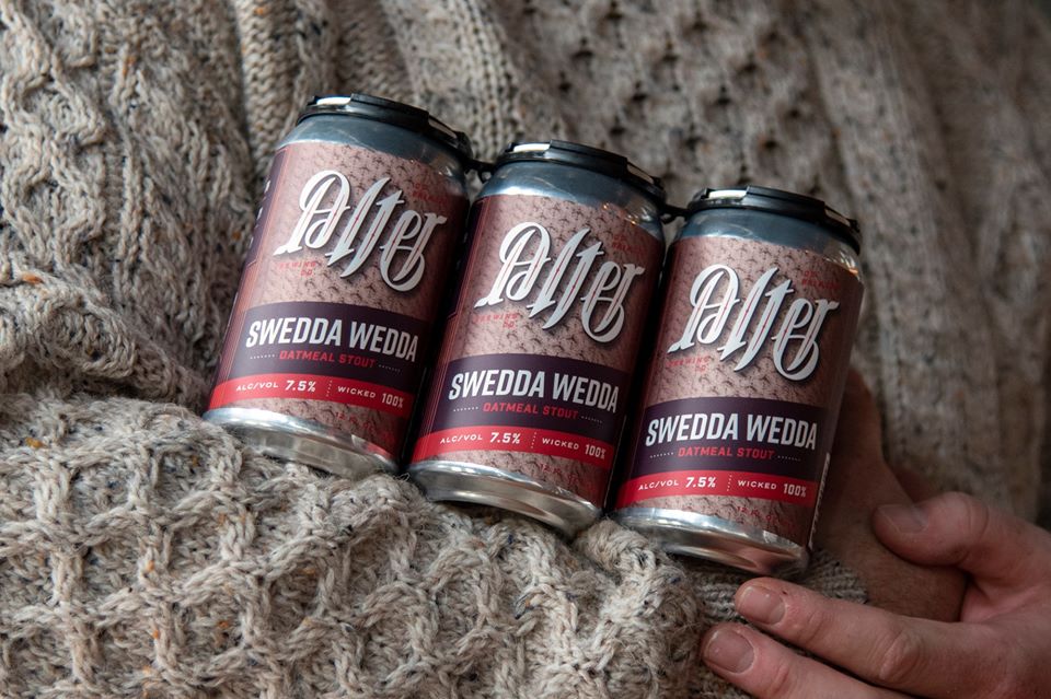 Person in Sweater holding 6 pack of Swedda Wedda by Alter Brewing Co.