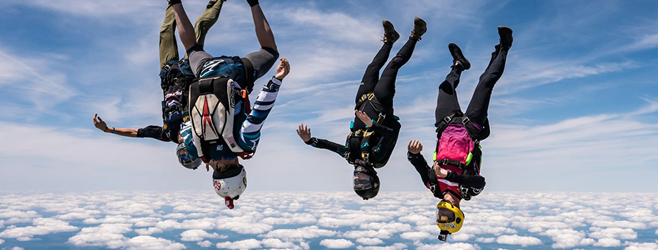 four people skydiving