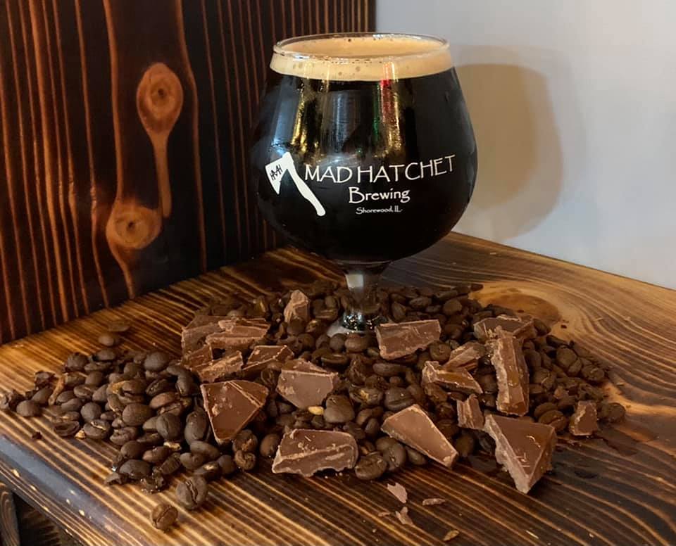 Glass of Beer in front of cocoa and coffee beans