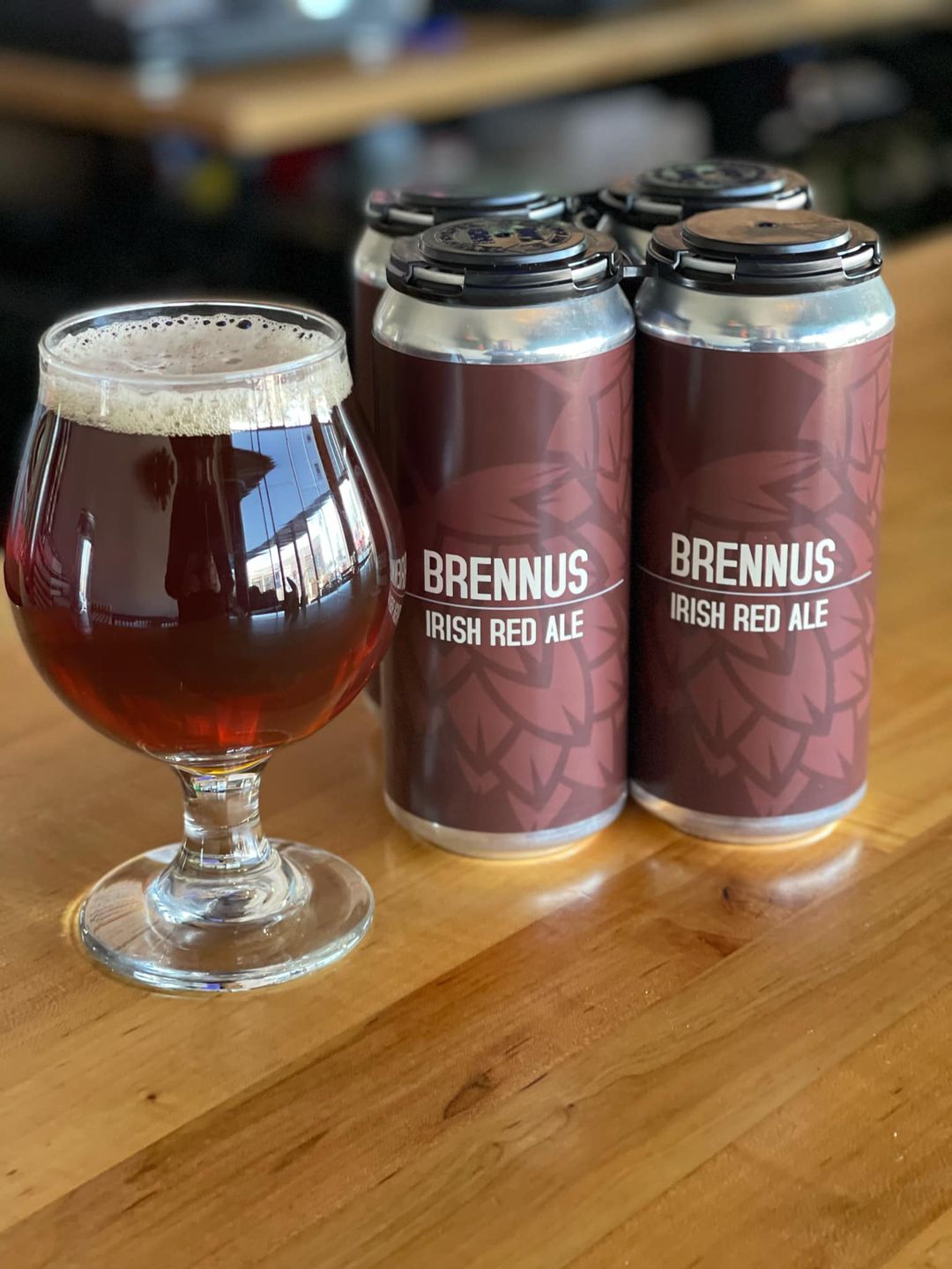 A four pack and a glass of Will County Brewing's Brennus