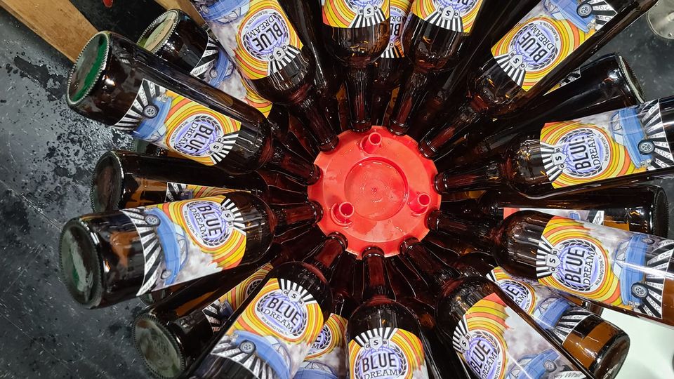 Several bottles of blue dream in a beer bucket